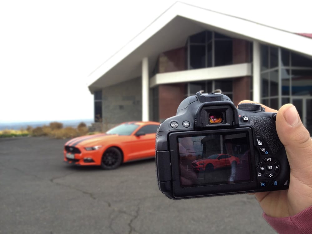 auto-dealer-website a professional photographer taking car photos