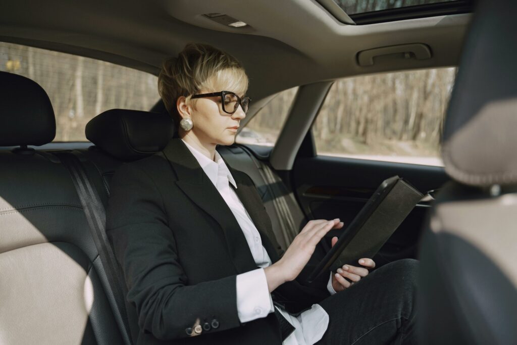 A woman doing F&I management insider her car.