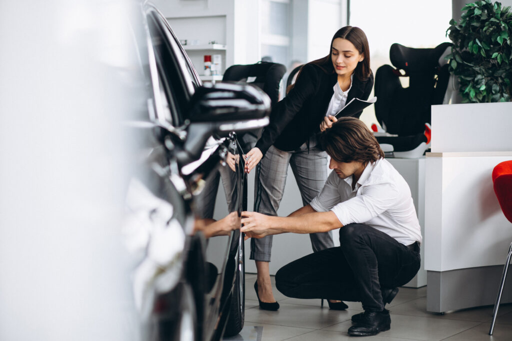 Dealer inspecting high-quality used vehicles at an auction.