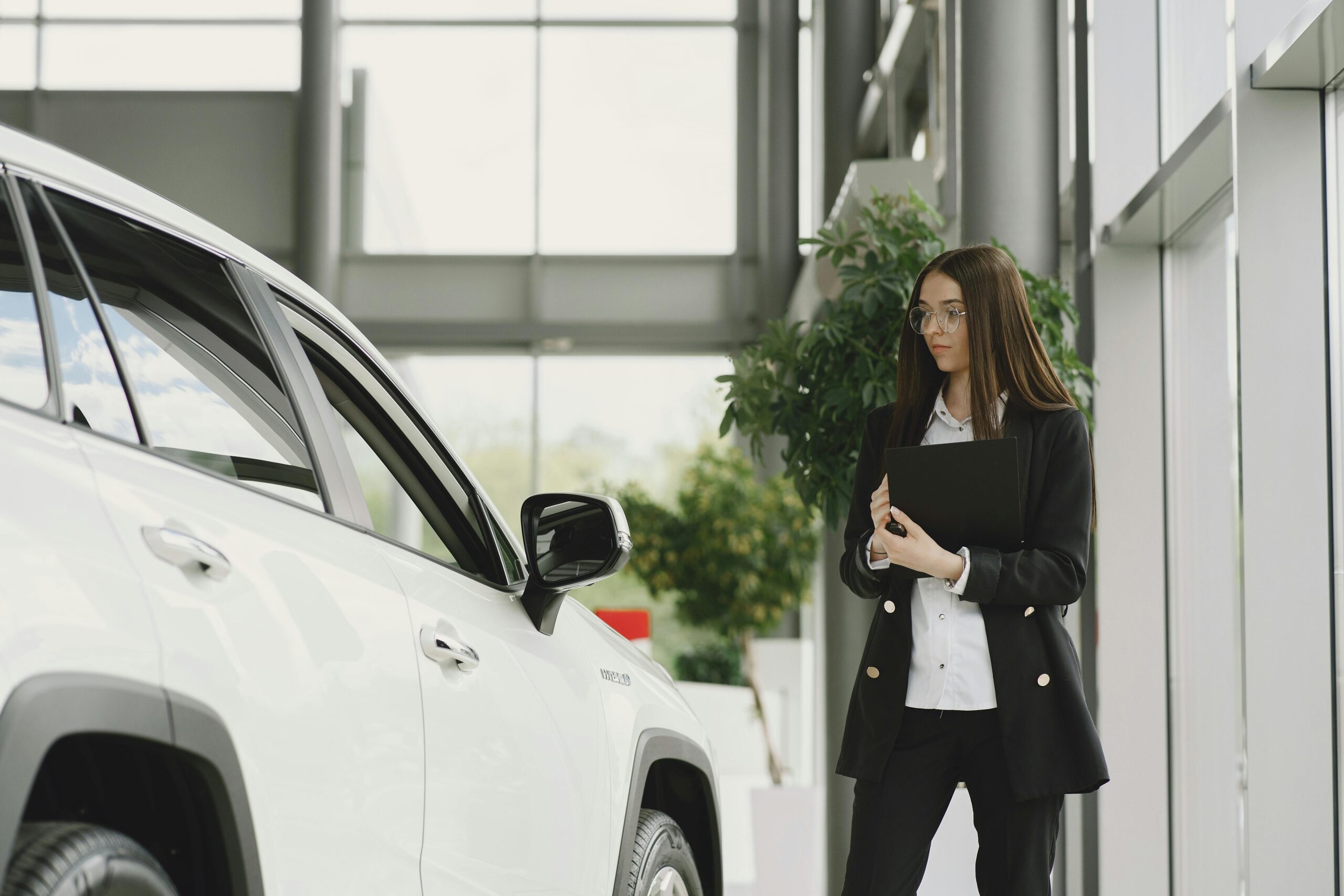 New independent car dealer reviewing inventory options in their dealership office.