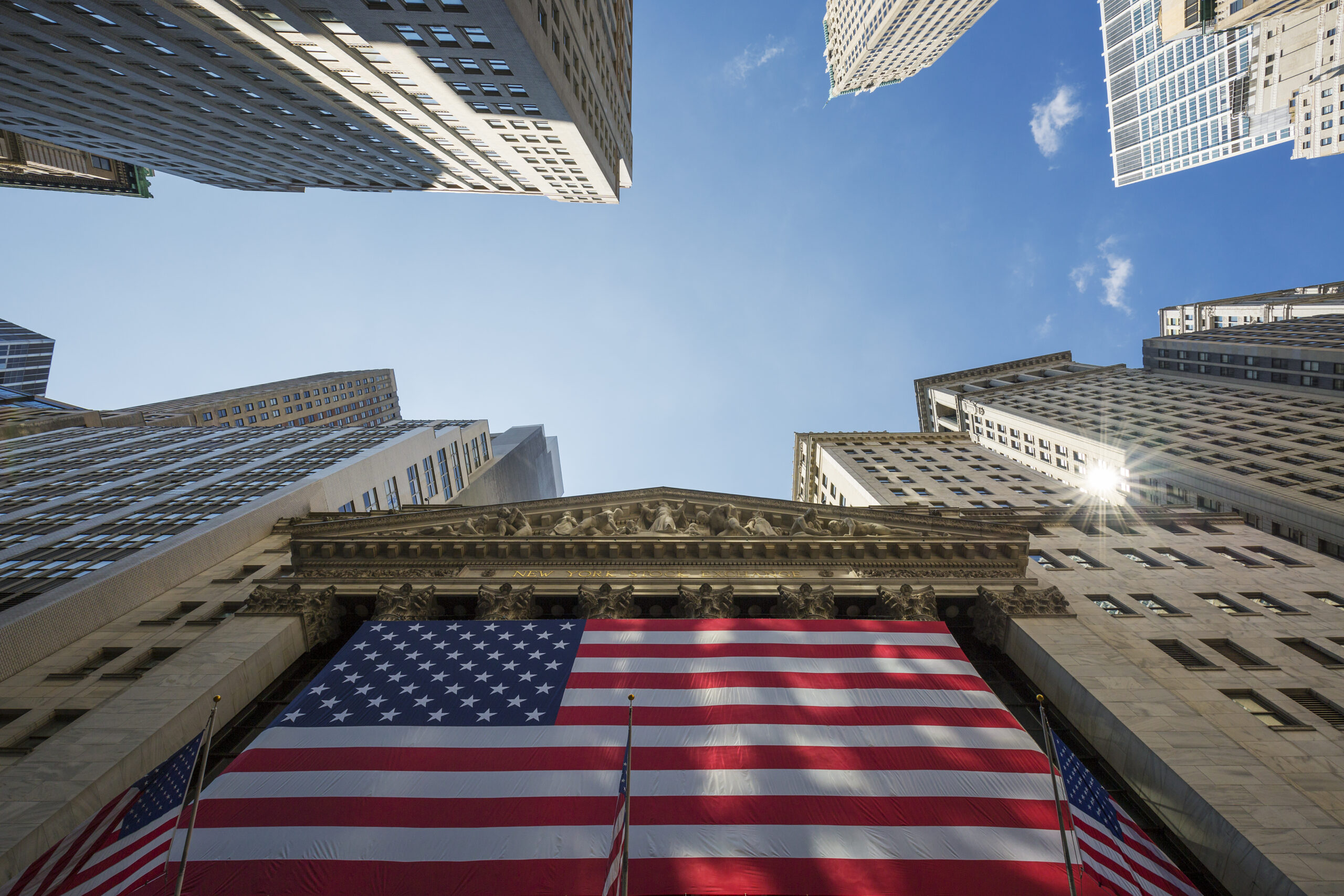 USA flag on a building, symbolizing the impact of Trump's tariffs on the American auto industry.