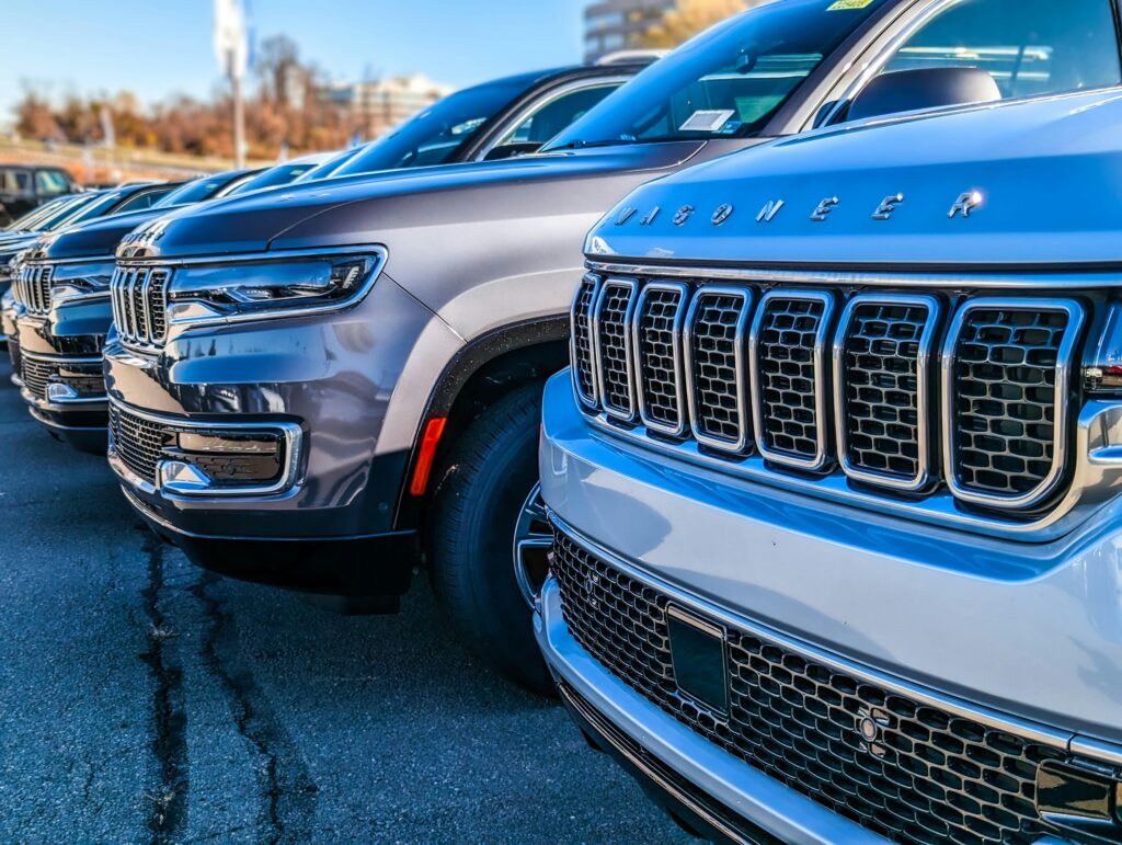 Car dealers and an F&I manager discussing backend profit strategies, analyzing data-driven insights to maximize dealership revenue and long-term profitability.